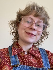 Lady with curly hair and red shirt